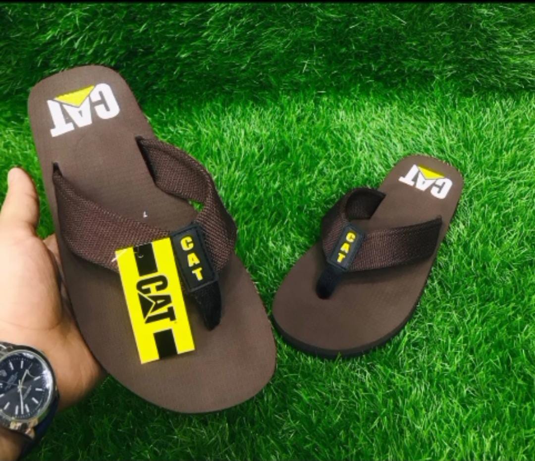 Man wearing Stride Nest slippers while standing on tiles